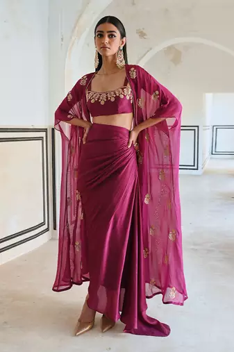 Magenta floral embroidered neckline bralet with floral butti embroidered jacket and cowl skirt.