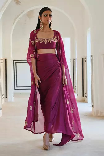 Magenta floral embroidered neckline bralet with floral butti embroidered jacket and cowl skirt.