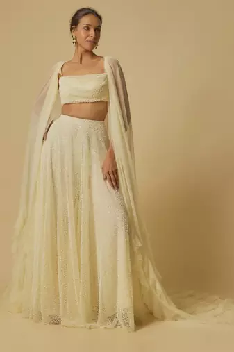 Yellow heavy embroidered gharara with blouse and ruffle cape