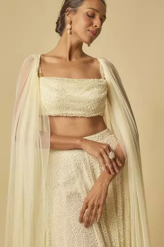 Yellow heavy embroidered gharara with blouse and ruffle cape