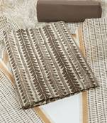 Brown unstitched suit set with traditional dabu print along with printed dupatta and solid bottom.