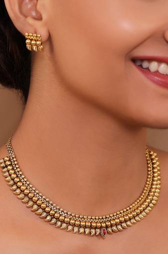 Charming antique gold delicate necklace set adorned with carved leaf patterns earrings