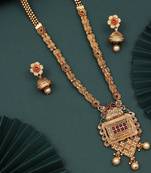 A lavish long antique necklace set with intricate ruby & green stones and jhumki earrings