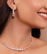 Asymmetrical american diamond rose gold polish necklace set paired with delicate long earrings