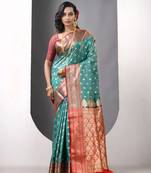 Teal satin silk blend emboss banarasi saree with zari woven ethnic motifs
