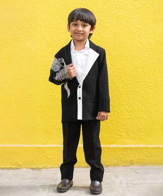 Stylish black blazer with silver embroidery and white lapel, paired with black trousers 1
