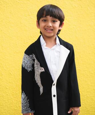 Stylish black blazer with silver embroidery and white lapel, paired with black trousers 2