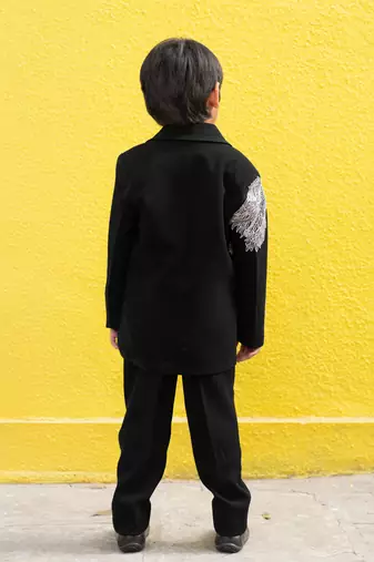 Stylish black blazer with silver embroidery and white lapel, paired with black trousers