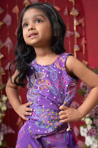 Add a pop of color to your celebrations with this vibrant purple printed top and flared palazzo set