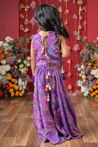 Add a pop of color to your celebrations with this vibrant purple printed top and flared palazzo set