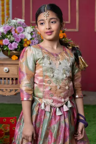 Shimmering pastel embroidered top and lehenga set with matching potli bag
