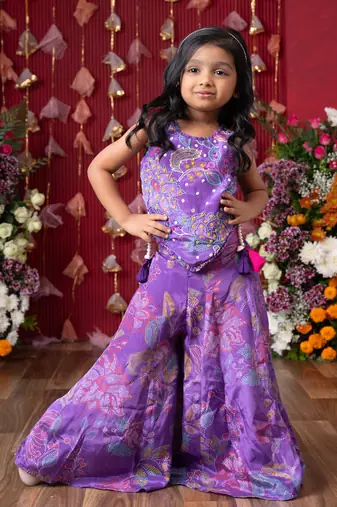 Add a pop of color to your celebrations with this vibrant purple printed top and flared palazzo set