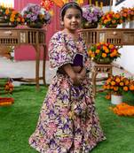 Elegant embroidered lehenga with attached floral cape and matching potli bag