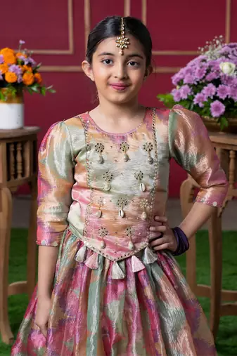 Shimmering pastel embroidered top and lehenga set with matching potli bag