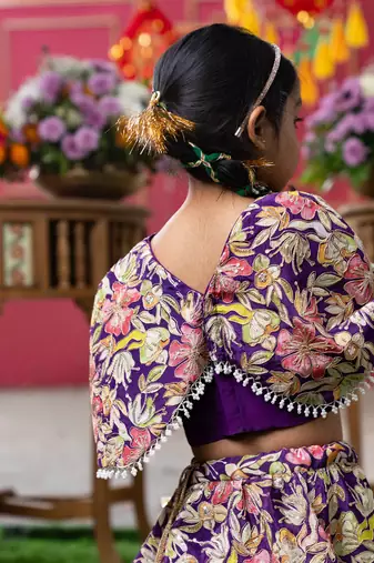 Elegant embroidered lehenga with attached floral cape and matching potli bag