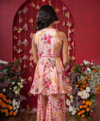 Floral elegance: a chic peplum set with matching potli for festive charm 3