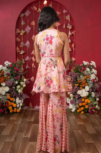 Floral elegance: a chic peplum set with matching potli for festive charm