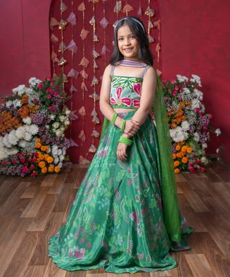 Grace your festivities with this vibrant green lehenga set, featuring floral embroidery and a flowy printed skirt 1