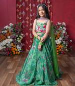 Grace your festivities with this vibrant green lehenga set, featuring floral embroidery and a flowy printed skirt