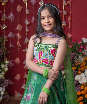Grace your festivities with this vibrant green lehenga set, featuring floral embroidery and a flowy printed skirt 2