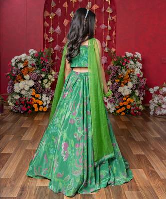 Grace your festivities with this vibrant green lehenga set, featuring floral embroidery and a flowy printed skirt 4