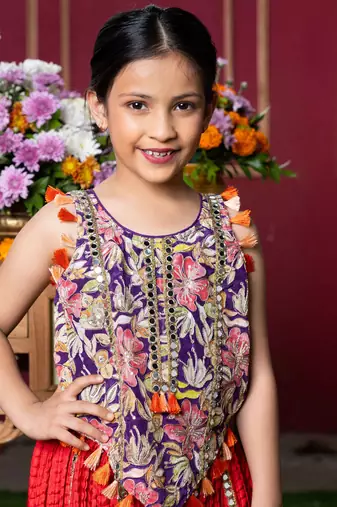 Vibrant embroidered kurti with tassels and red mirror work sharara pants