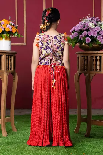 Vibrant embroidered kurti with tassels and red mirror work sharara pants