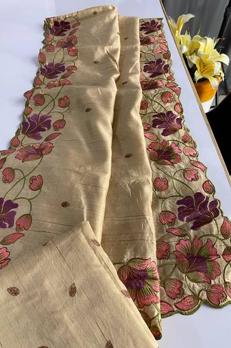 Cream tussar silk saree with all over contrast embroidery work and motifs with cutwork border