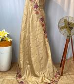 Cream tussar silk saree with all over contrast embroidery work and motifs with cutwork border