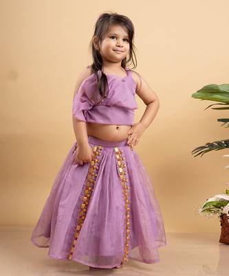 Chic lavender lehenga with an asymmetrical top, adorned with gold and pink embellishments for a modern festive look. 1