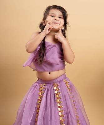 Chic lavender lehenga with an asymmetrical top, adorned with gold and pink embellishments for a modern festive look. 2