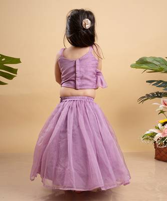 Chic lavender lehenga with an asymmetrical top, adorned with gold and pink embellishments for a modern festive look. 3