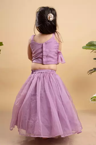 Chic lavender lehenga with an asymmetrical top, adorned with gold and pink embellishments for a modern festive look.