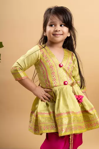 Vibrant lime green printed kurta paired with bold fuchsia dhoti pants for a festive and playful look