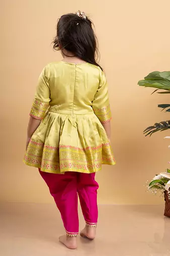 Vibrant lime green printed kurta paired with bold fuchsia dhoti pants for a festive and playful look