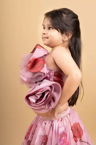 Charming off-shoulder pink ruffle top paired with a flowy floral lehenga for a delightful festive look