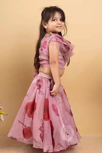 Charming off-shoulder pink ruffle top paired with a flowy floral lehenga for a delightful festive look