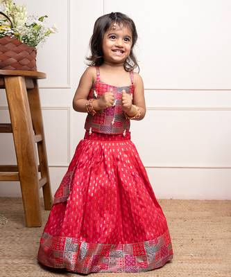 Vibrant red lehenga set with a multicolored patchwork blouse and golden motif print, perfect for festive occasions 1