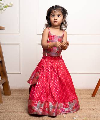Vibrant red lehenga set with a multicolored patchwork blouse and golden motif print, perfect for festive occasions 2