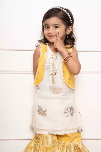 Charming ivory and yellow sharara set with delicate silver floral embroidery and playful appliqu  s