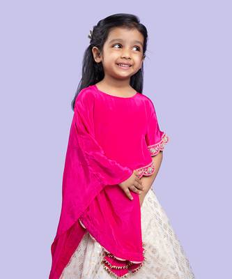 Elegant pink cape top with a white and gold lehenga, perfect for festive celebrations 2