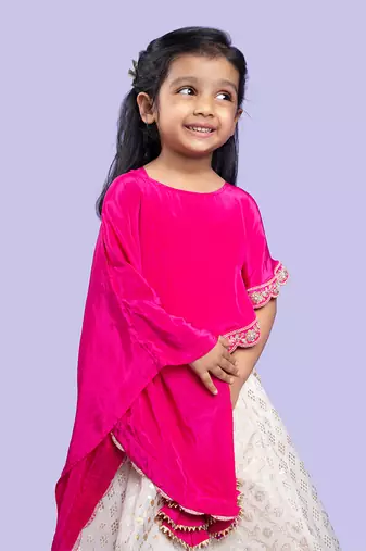 Elegant pink cape top with a white and gold lehenga, perfect for festive celebrations