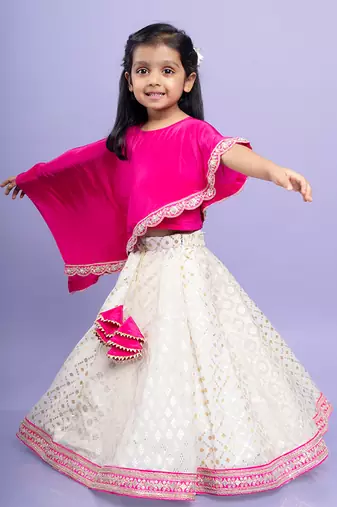 Elegant pink cape top with a white and gold lehenga, perfect for festive celebrations