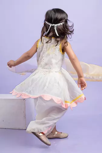 Charming white dhoti-style set with floral embroidery and playful yellow and pink accents, perfect for festive occasions
