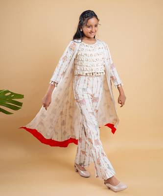 Vibrant ivory ensemble with colorful prints and tassel accents 1