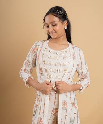 Vibrant ivory ensemble with colorful prints and tassel accents 2