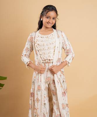 Vibrant ivory ensemble with colorful prints and tassel accents 3
