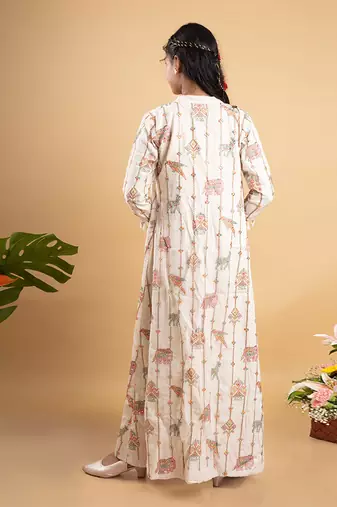 Vibrant ivory ensemble with colorful prints and tassel accents