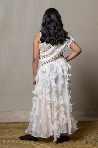 Elegant ivory one-shoulder gown with cascading ruffles and sequin embellishments