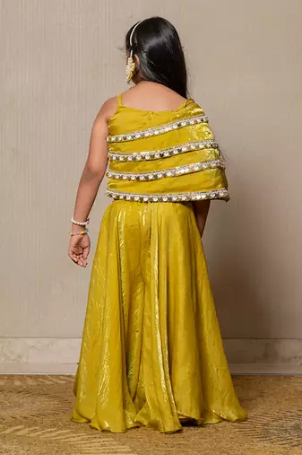 Vibrant golden-yellow ensemble with an asymmetrical top and wide-legged pants